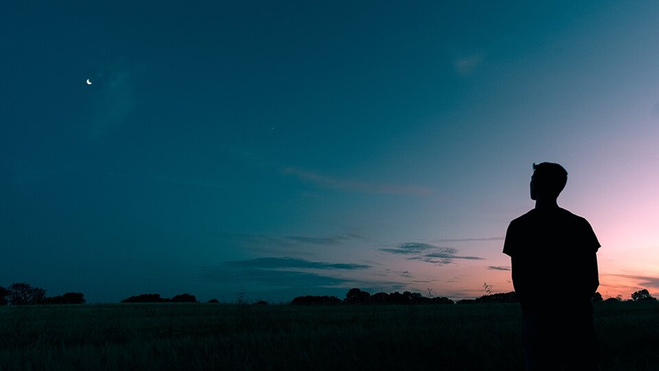 Man sitting alone, staring off into space