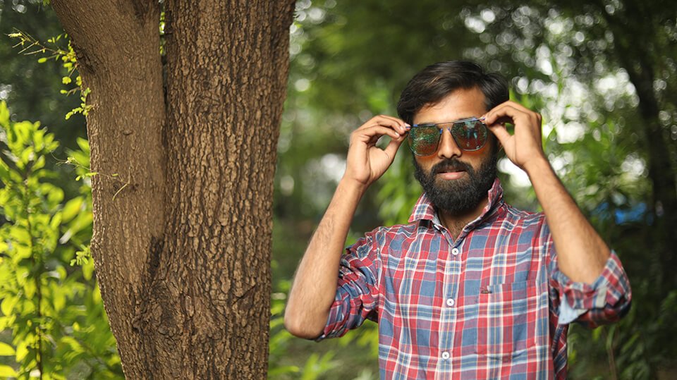 Man putting on sunglasses