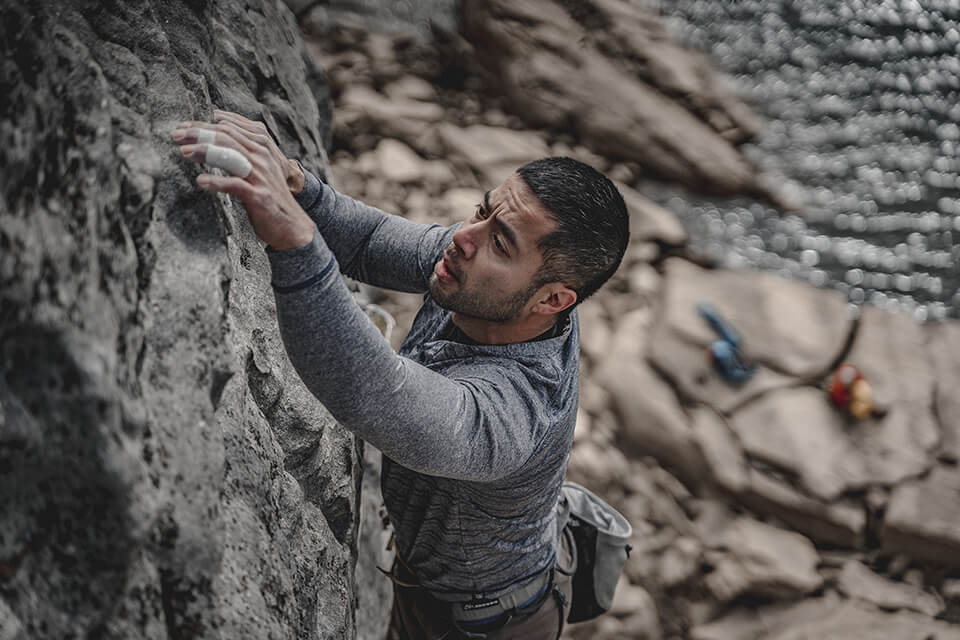 Man climbing up a cliff