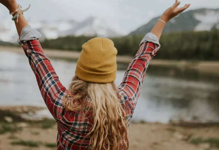 a woman with her hands up in the air.