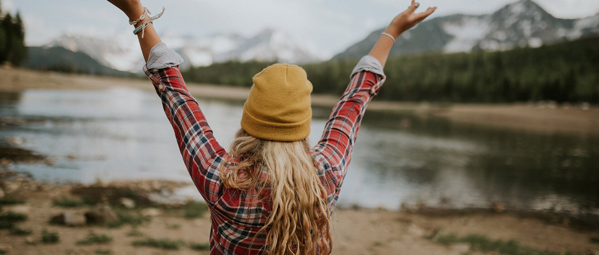 a woman with her hands up in the air.