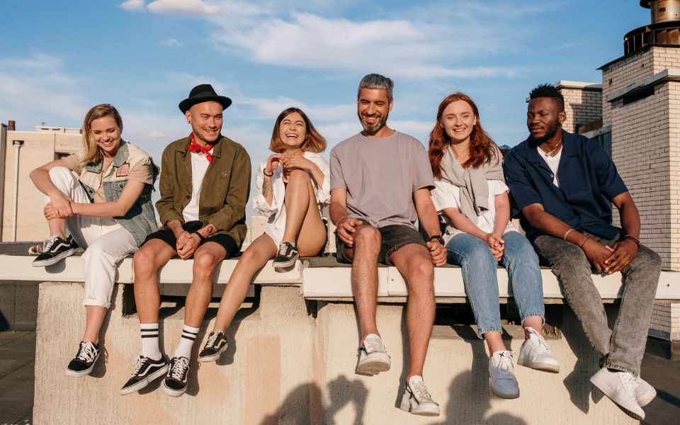 group of diverse friends hanging out on a ledge