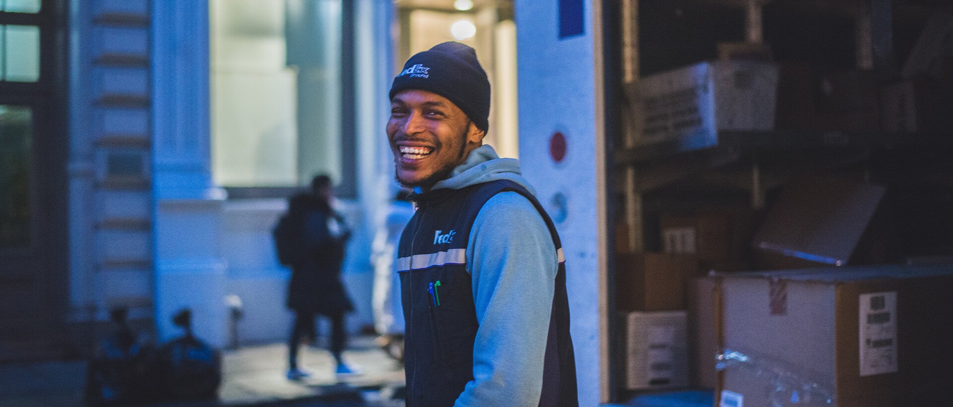 a man standing in front of a building smiling.