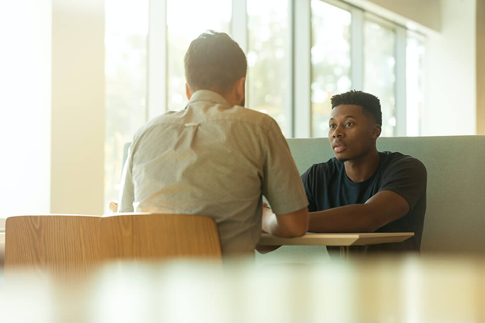 Two men having an intense conversation in an office