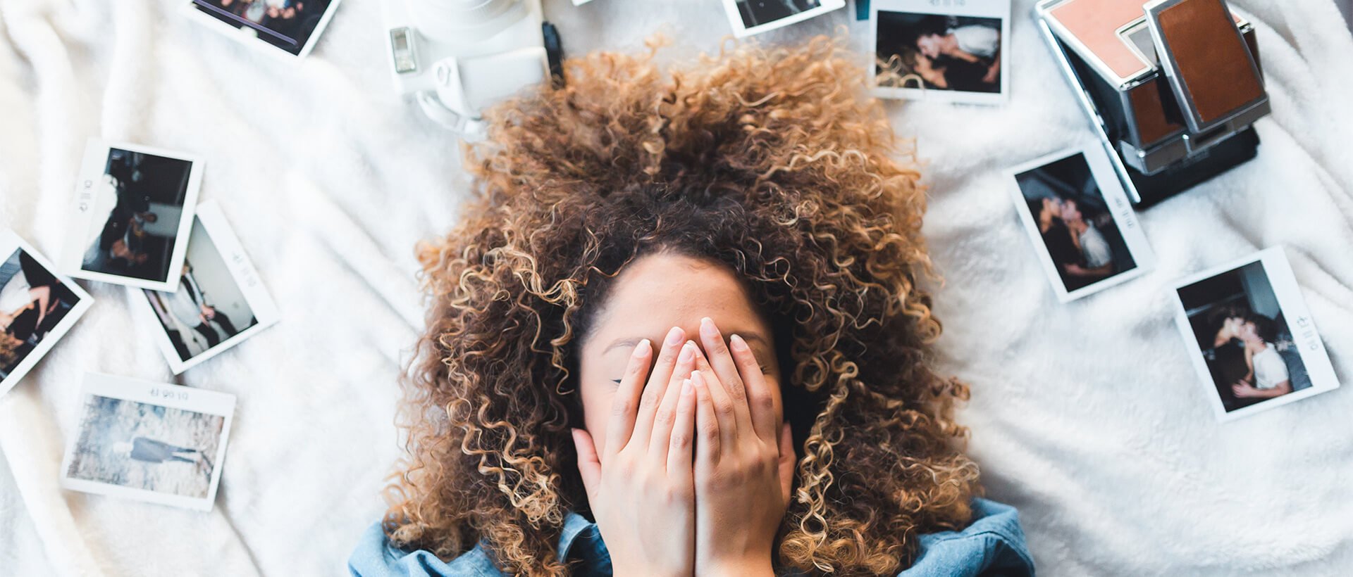 a woman covering her face with her hands.