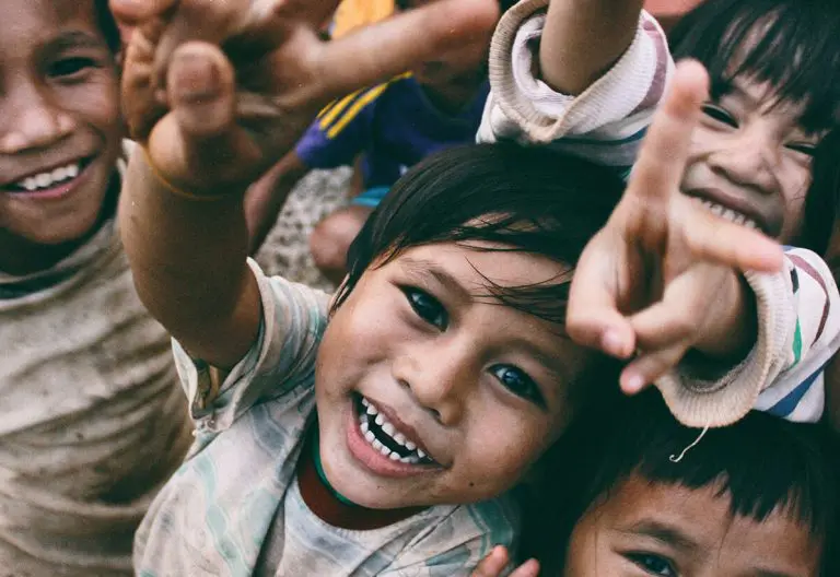 a group of young children standing next to each other.