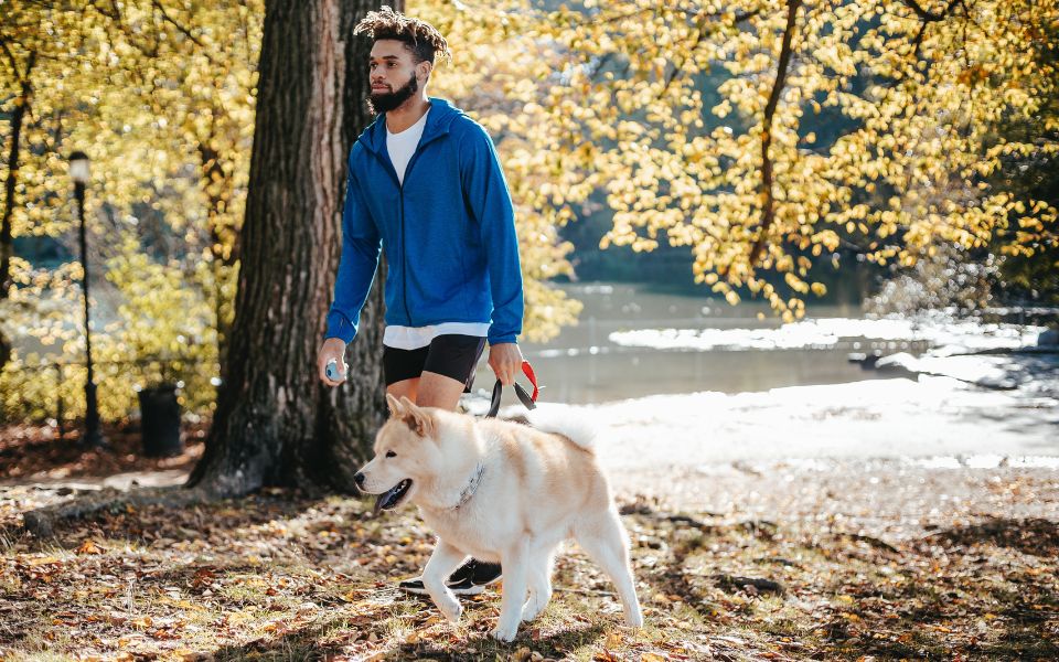 man goes on nature walk with dog to have a good day