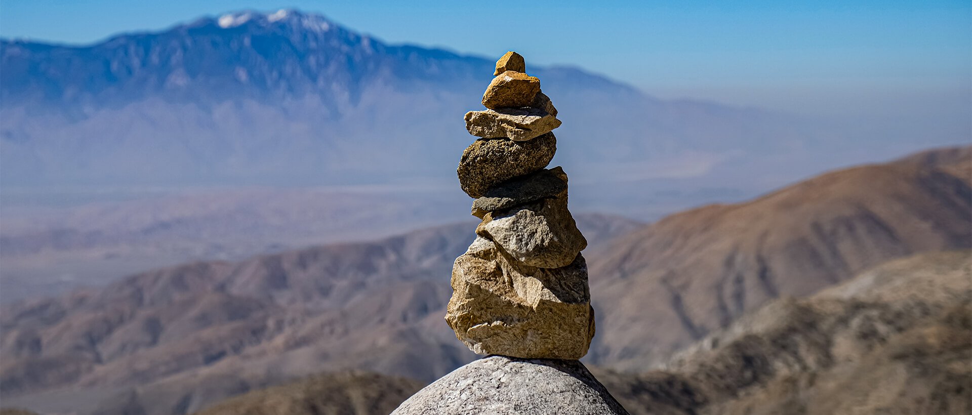 a stack of rocks sitting on top of a mountain.