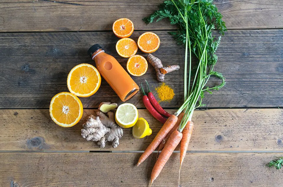 A table with vegetables and juices on display