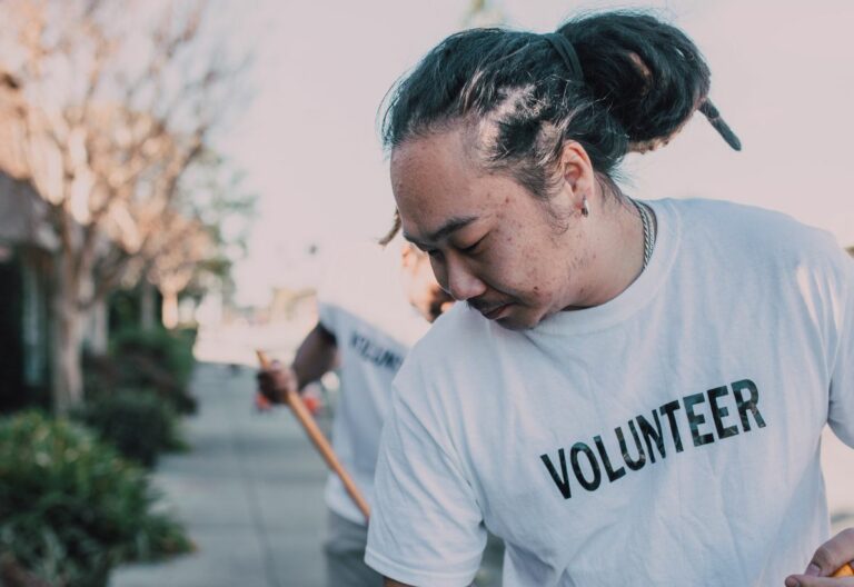 a man holding a baseball bat while wearing a volunteer t - shirt.