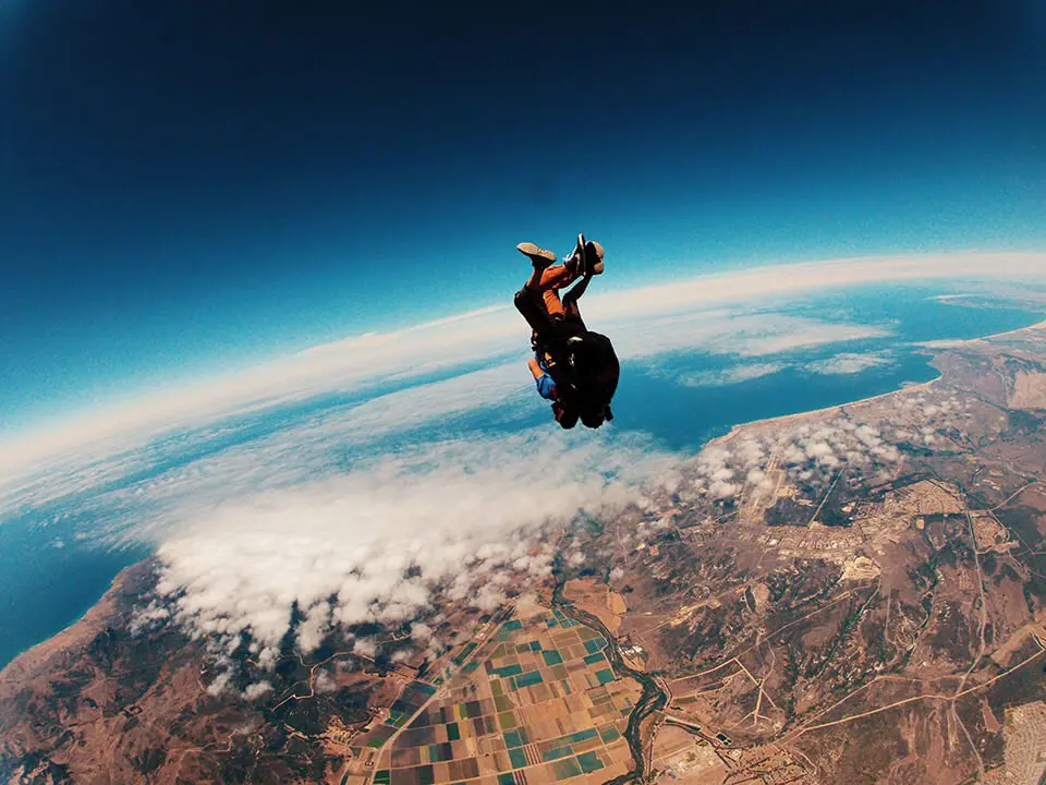 Skydiver floating above the clouds