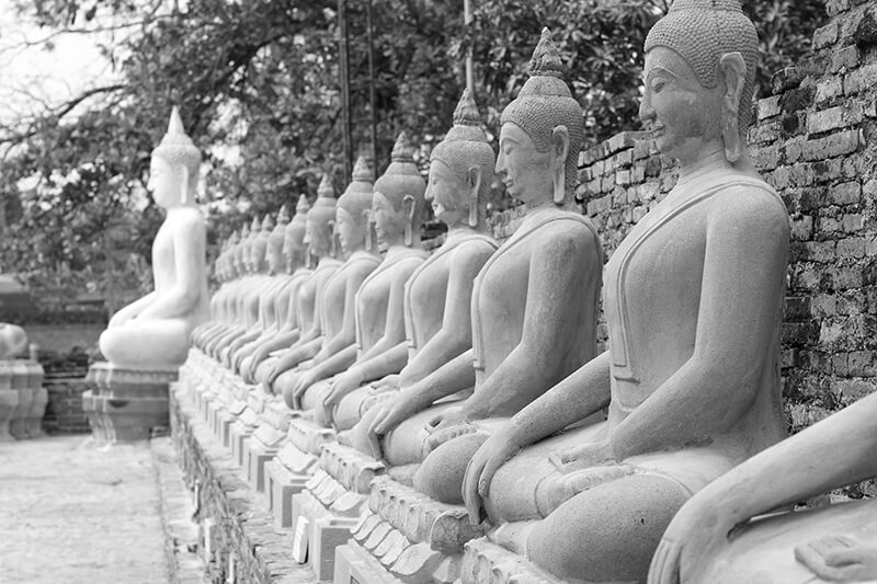 Buddhist statues seated next to one another