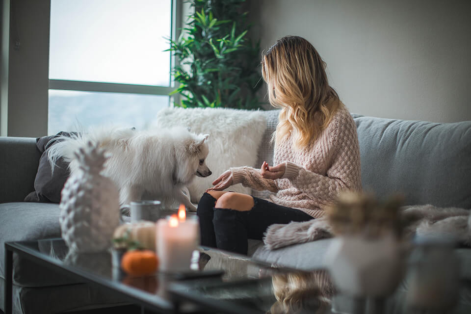 Woman taking a mental break to play with her dog