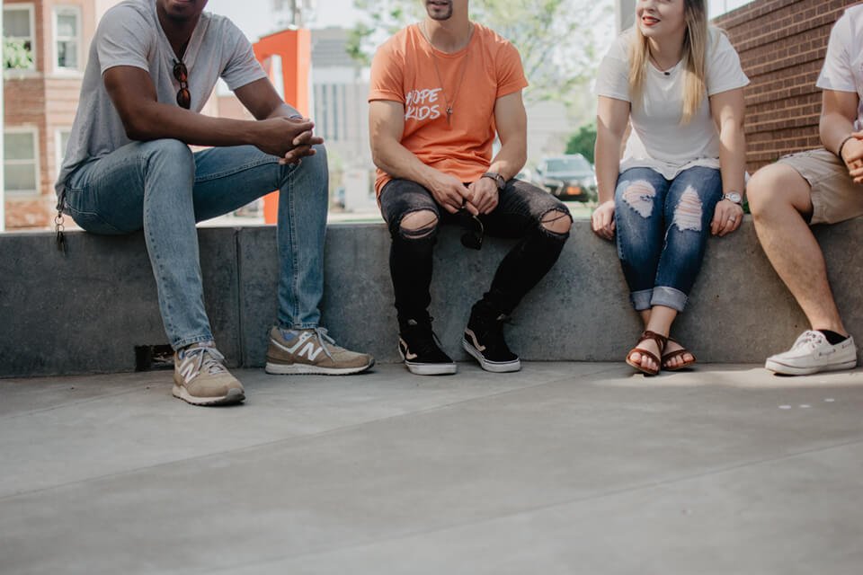 A group of friends sitting outside having a conversation