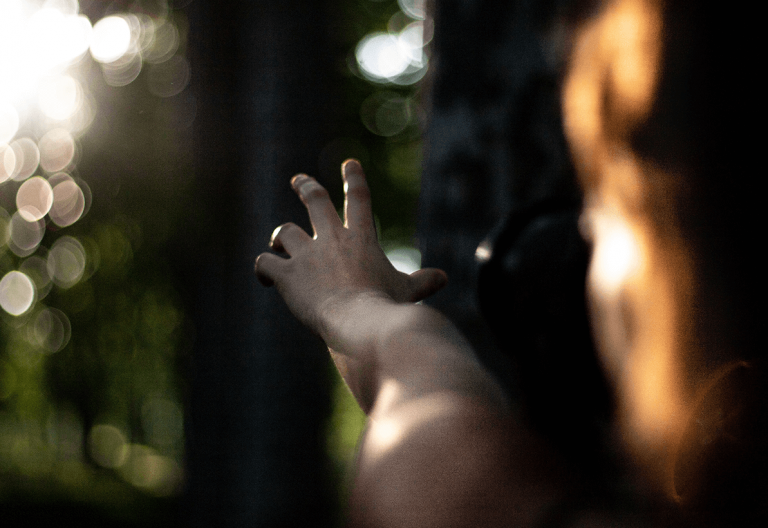 a person holding their hand up in the air.