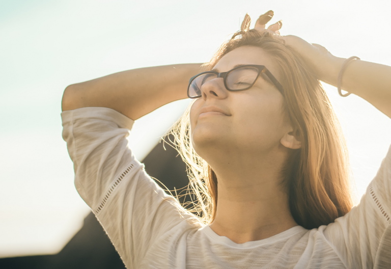 a woman with her hands on her head.